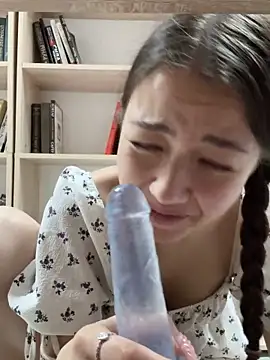Diana sucks a dildo and jumps on it in the library